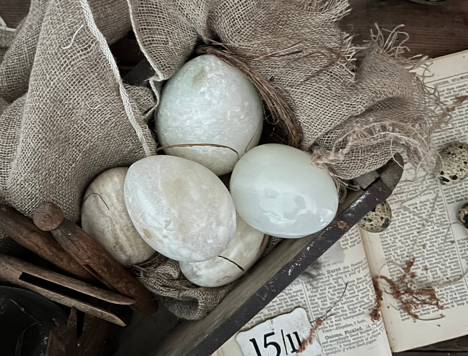 A collection of kitchenalia items including a baker shaped pie funnel, vintage cookie cutters and small vintage spoons